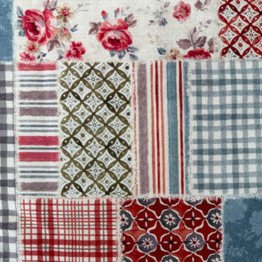 This wide cotton backing fabric features a classic patchwork design combining florals, checks, and geometric patterns in muted red, grey, blue, and cream tones.
