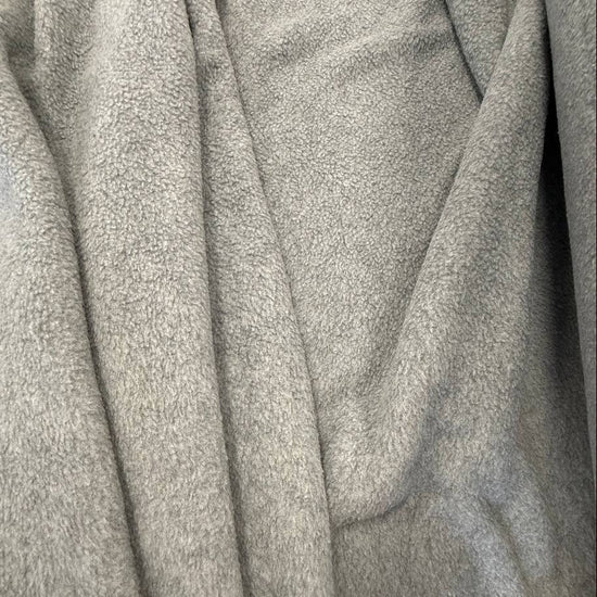 Soft and warm polar fleece fabric in a light grey melange color.