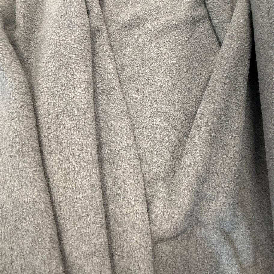 Soft and warm polar fleece fabric in a light grey melange color.