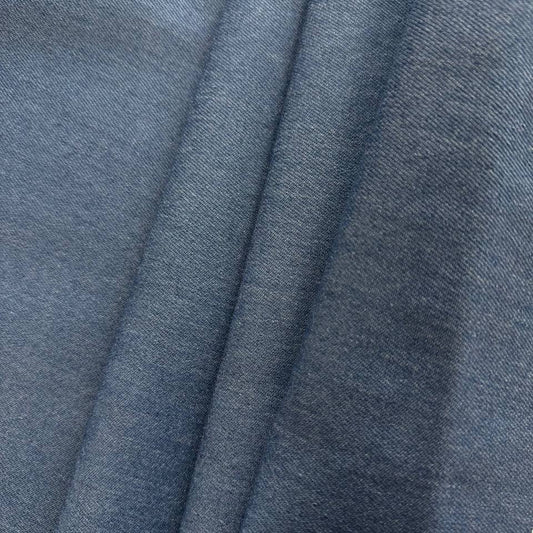 Denim blue stretch denim fabric folded showing smooth woven texture