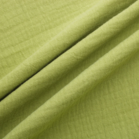 Sage green double gauze cotton fabric with soft crinkled texture