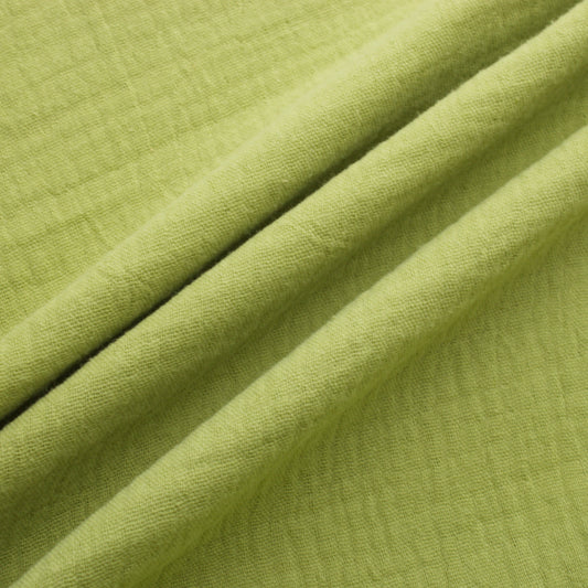 Sage green double gauze cotton fabric with soft crinkled texture