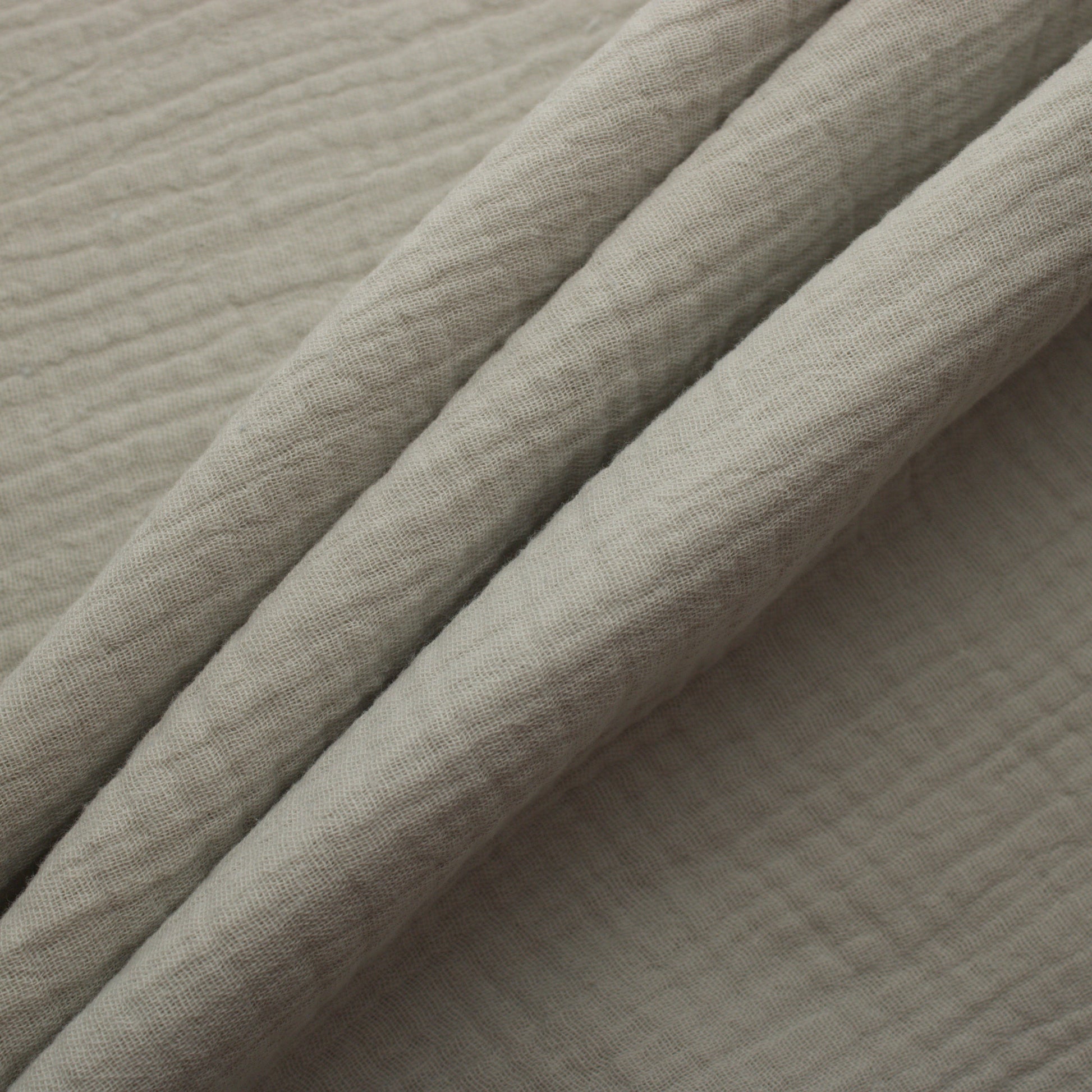 Off white double gauze cotton fabric with soft crinkled texture