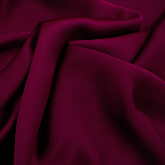 Majestic satin fabric drape in magenta, lightweight polyester satin with fluid movement

