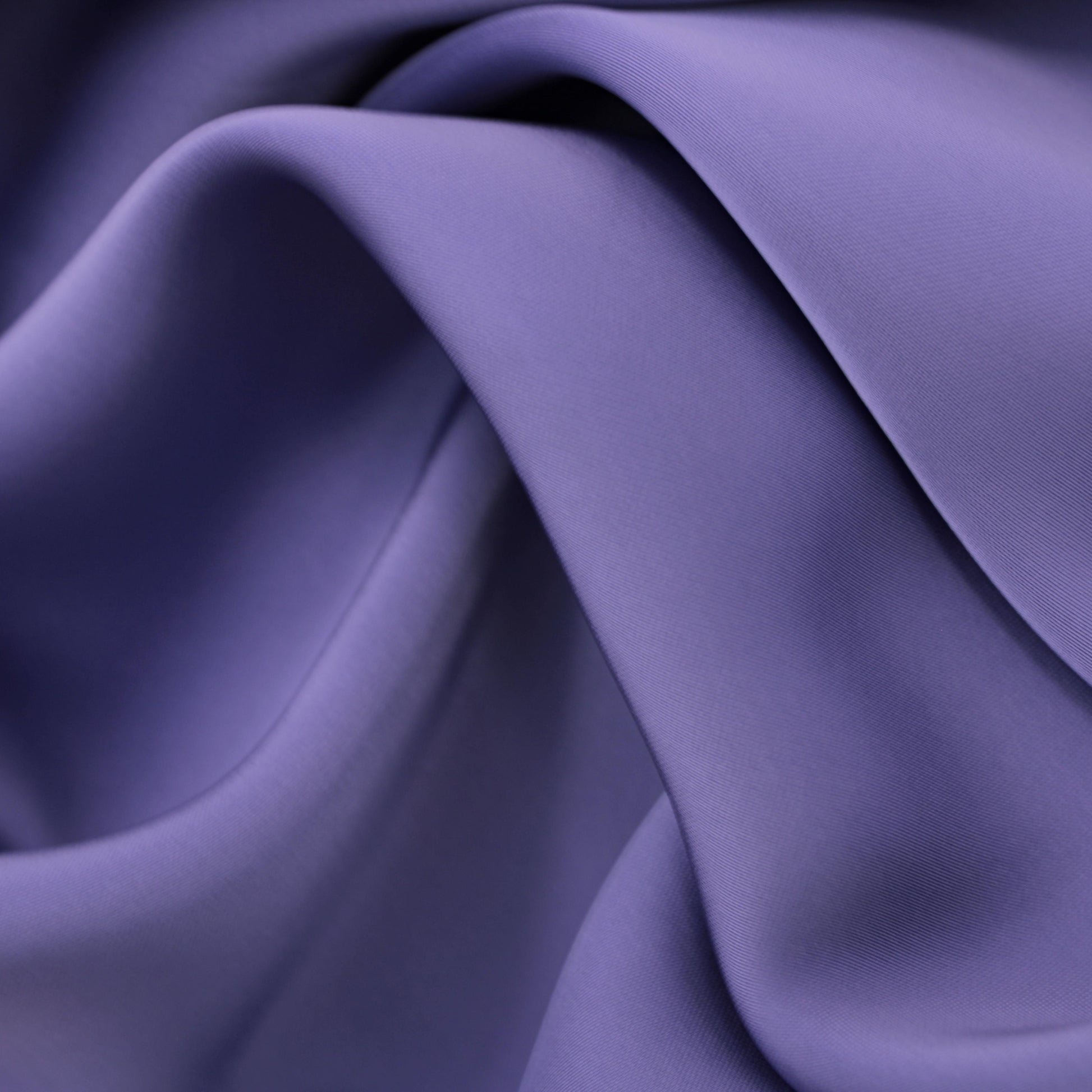 Satin fabric in mauve color, smooth polyester satin on fabric roll
