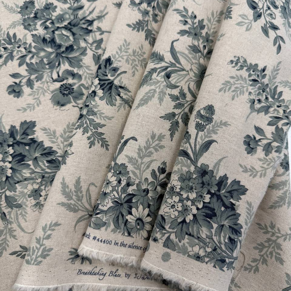 Breathtaking Blues by 3 Sisters for Moda cotton linen fabric with vintage blue floral bouquets on a natural background.