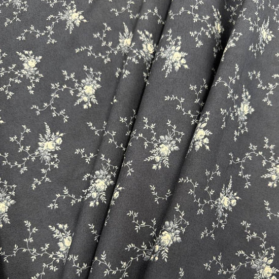 Breathtaking Blues Midnight 100% cotton fabric by 3 Sisters for Moda Fabrics featuring cream floral vine motifs on a deep blue background.