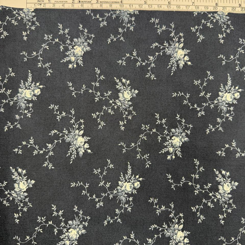 Breathtaking Blues Midnight 100% cotton fabric by 3 Sisters for Moda Fabrics featuring cream floral vine motifs on a deep blue background.