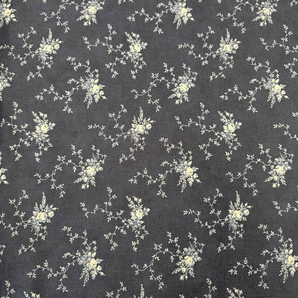 Breathtaking Blues Midnight 100% cotton fabric by 3 Sisters for Moda Fabrics featuring cream floral vine motifs on a deep blue background.
