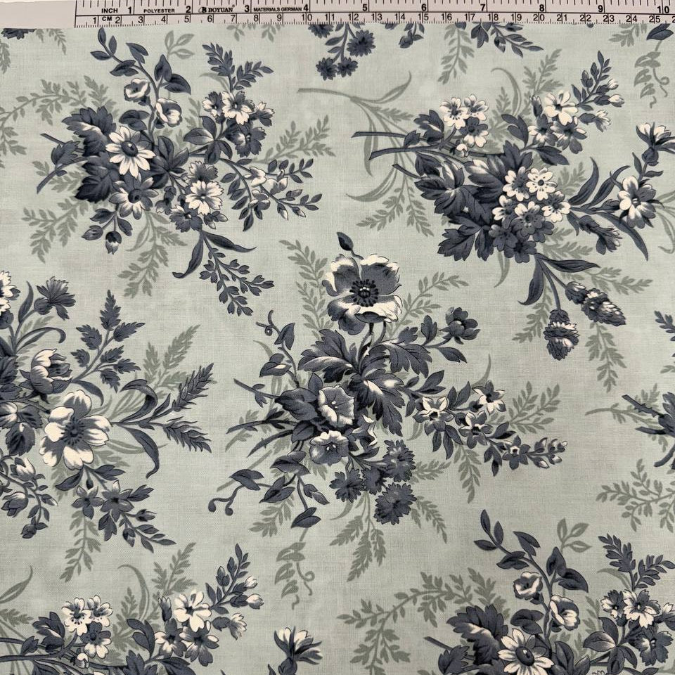 Breathtaking Blues Sky cotton fabric by 3 Sisters for Moda Fabrics featuring vintage blue and cream floral bouquets on a soft sky blue background.