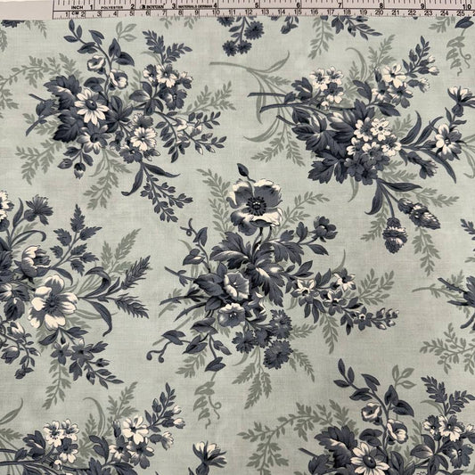 Breathtaking Blues Sky cotton fabric by 3 Sisters for Moda Fabrics featuring vintage blue and cream floral bouquets on a soft sky blue background.