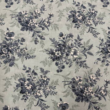 Breathtaking Blues Sky cotton fabric by 3 Sisters for Moda Fabrics featuring vintage blue and cream floral bouquets on a soft sky blue background.