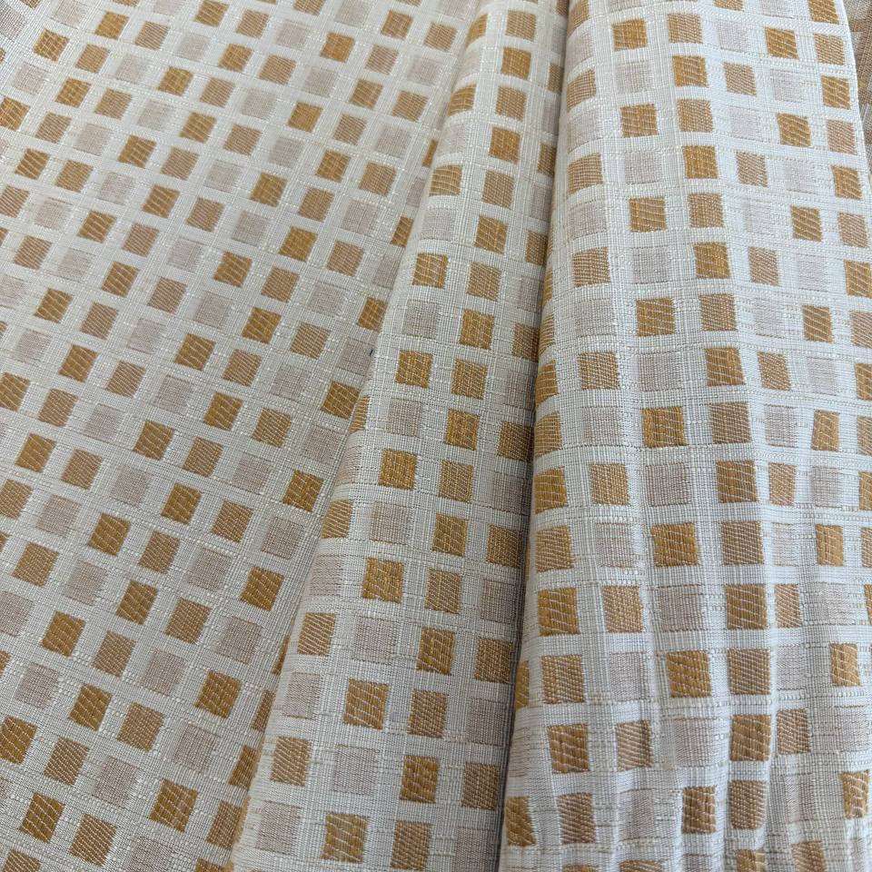 Cream and gold upholstery fabric with a small woven geometric square pattern, suitable for decorative pillows, cushions, furniture upholstery, and home décor.