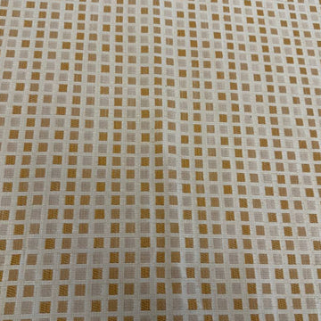 Cream and gold upholstery fabric with a small woven geometric square pattern, suitable for decorative pillows, cushions, furniture upholstery, and home décor.