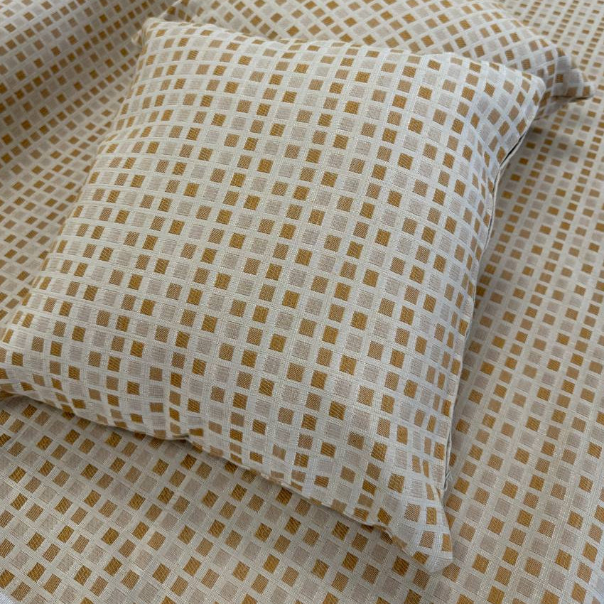Cream and gold upholstery fabric with a small woven geometric square pattern, suitable for decorative pillows, cushions, furniture upholstery, and home décor.