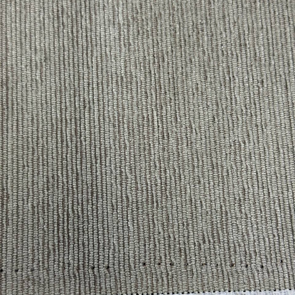 Taupe grey textured upholstery fabric with a raised vertical woven pattern for home décor and furniture projects.