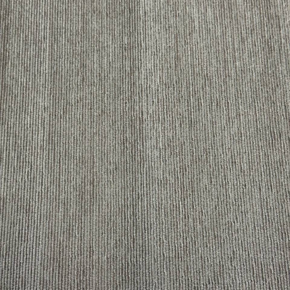Taupe grey textured upholstery fabric with a raised vertical woven pattern for home décor and furniture projects.