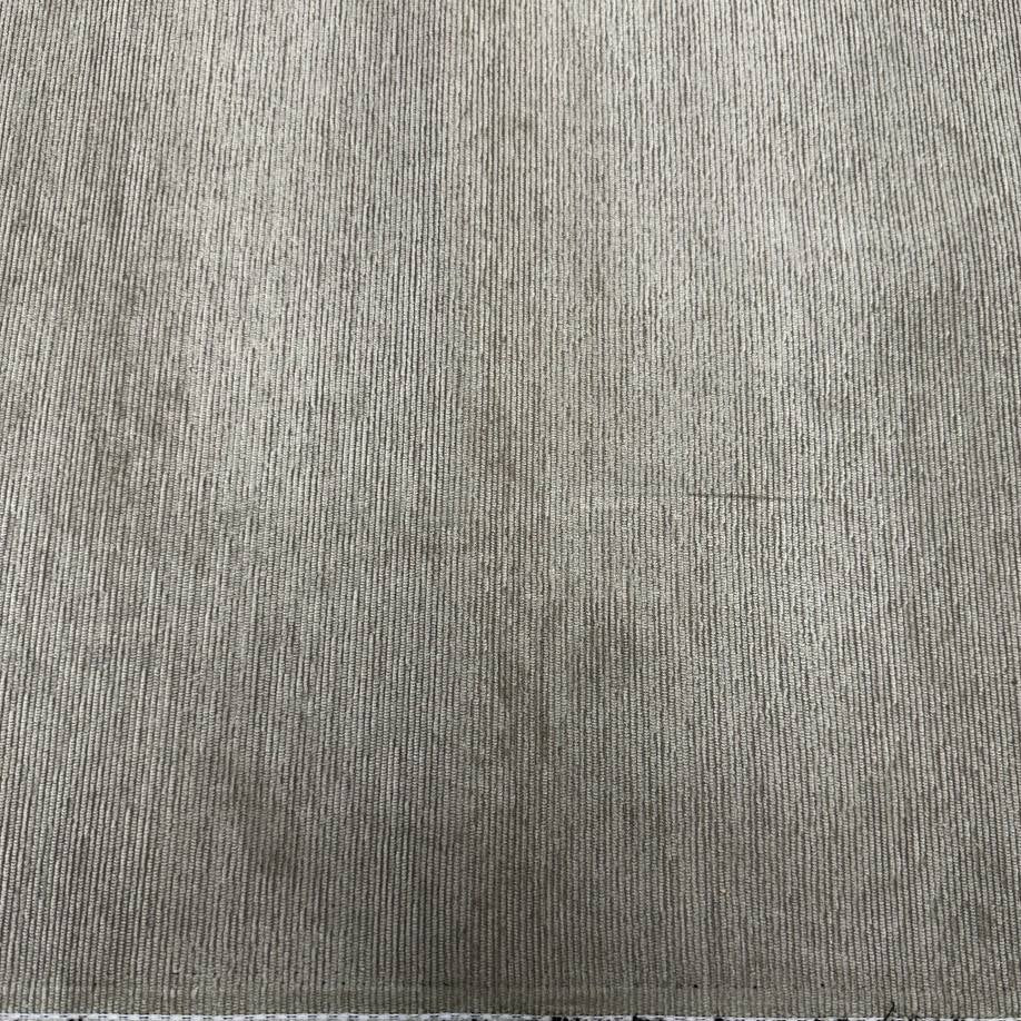 Muted sage green home décor fabric with a fine vertical ribbed texture and subtle grey undertones.