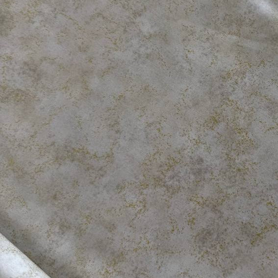 Stack of Northcott Shimmer Basics speckled quilting cotton fabrics in pastel shades with subtle metallic shimmer.