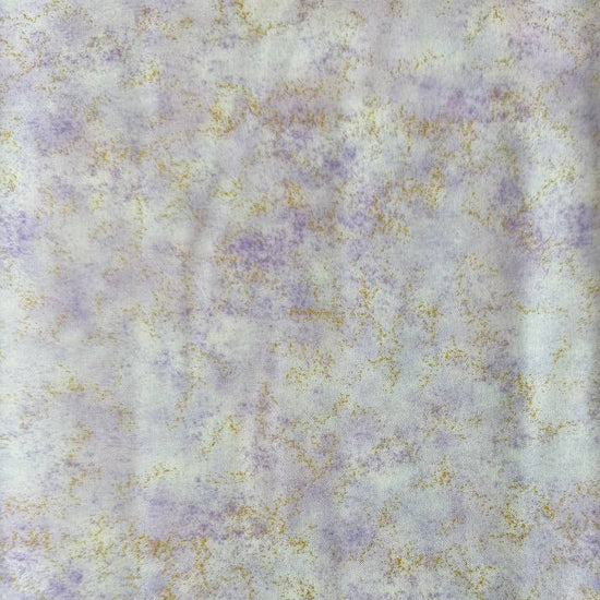 Stack of Northcott Shimmer Basics speckled quilting cotton fabrics in pastel shades with subtle metallic shimmer.