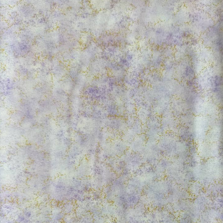 Stack of Northcott Shimmer Basics speckled quilting cotton fabrics in pastel shades with subtle metallic shimmer.