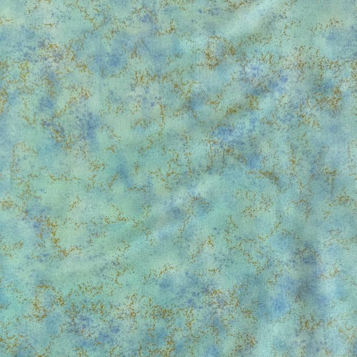 Stack of Northcott Shimmer Basics speckled quilting cotton fabrics in pastel shades with subtle metallic shimmer.