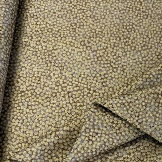 Abstract dotted fabric with a dense textured pattern and organic allover design, suitable for quilting, apparel, and craft sewing projects.