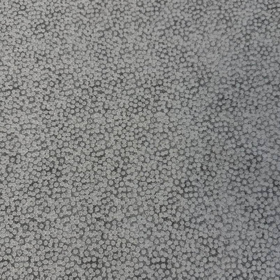 Abstract dotted fabric with a dense textured pattern and organic allover design, suitable for quilting, apparel, and craft sewing projects.