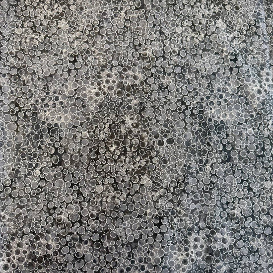 Fabric with an abstract all-over circular bubble pattern in mixed sizes and textured detailing.
