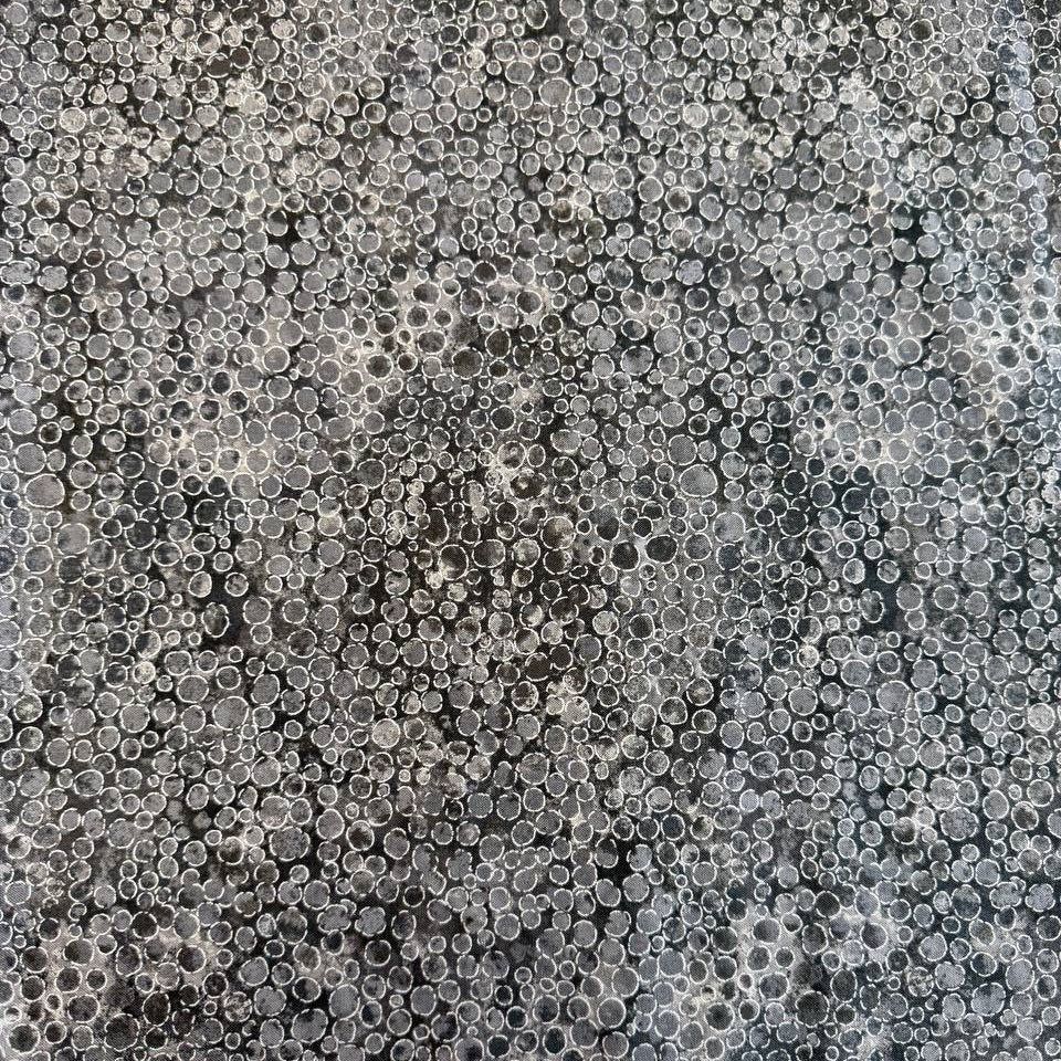 Fabric with an abstract all-over circular bubble pattern in mixed sizes and textured detailing.