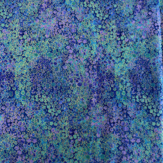Fabric with an abstract all-over circular bubble pattern in mixed sizes and textured detailing.