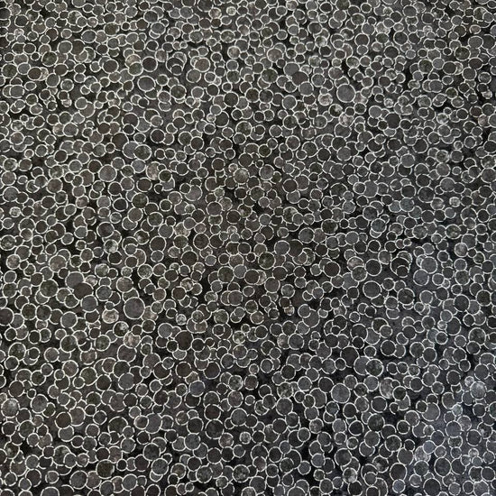Fabric featuring an abstract all-over pattern of layered circular bubble motifs in varying sizes with a textured artistic design.