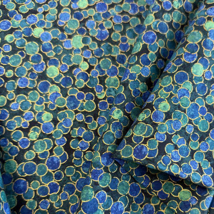 Fabric featuring an abstract all-over pattern of layered circular bubble motifs in varying sizes with a textured artistic design.