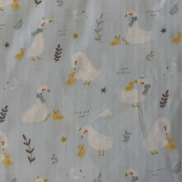 Little Ducklings double gauze fabric with duck and swan print available in two colors.