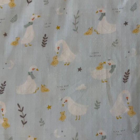 Little Ducklings double gauze fabric with duck and swan print available in two colors.