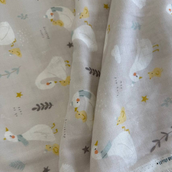 Little Ducklings double gauze fabric with duck and swan print available in two colors.