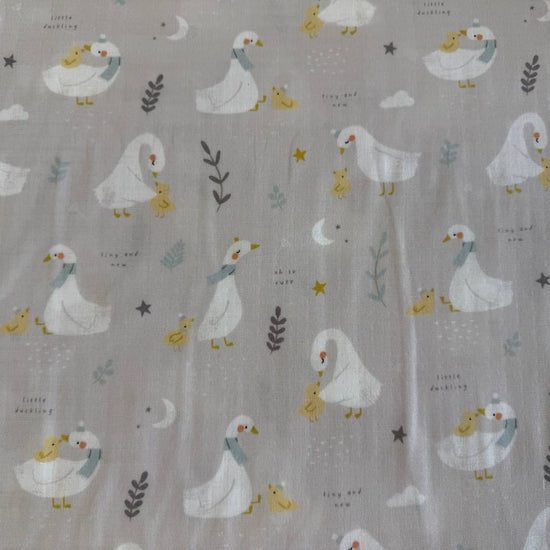 Little Ducklings double gauze fabric with duck and swan print available in two colors.