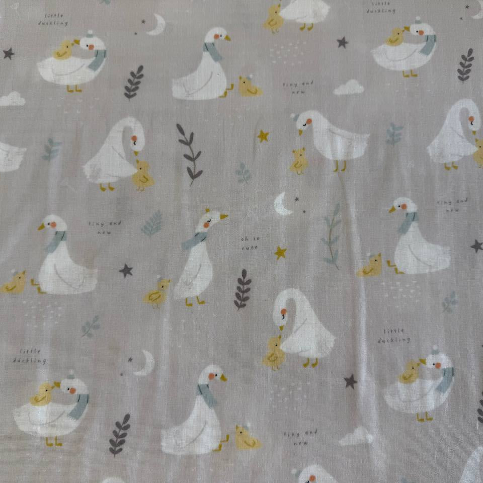 Little Ducklings double gauze fabric with duck and swan print available in two colors.