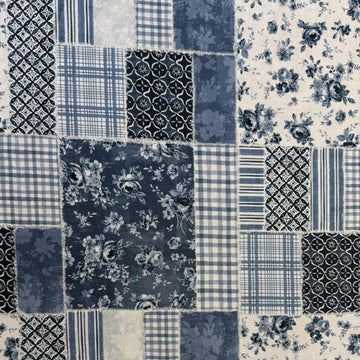 Moda Wide Essential 108 inch cotton quilt backing fabric with patchwork inspired print folded on fabric bolt display.