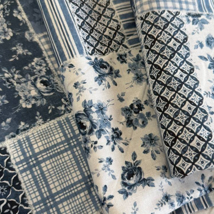 Moda Wide Essential 108 inch cotton quilt backing fabric with patchwork inspired print folded on fabric bolt display.