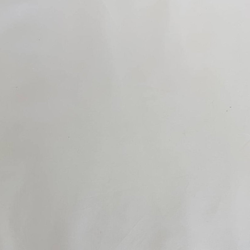 Extra wide 100% cotton premium muslin fabric folded on bolt in fabric shop.