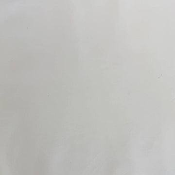 Extra wide 100% cotton premium muslin fabric folded on bolt in fabric shop.