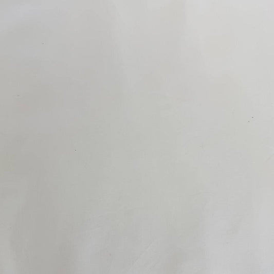 Extra wide 100% cotton premium muslin fabric folded on bolt in fabric shop.