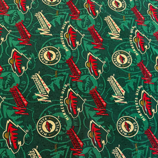 Licensed Minnesota Wild NHL cotton fabric with repeating team logos and hockey-themed print on cotton fabric.
