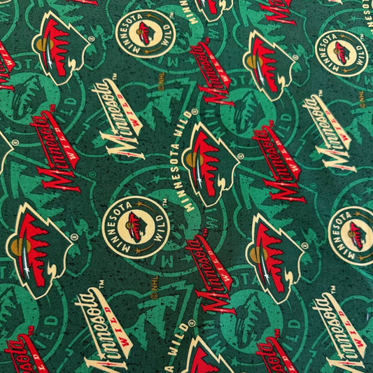 Licensed Minnesota Wild NHL cotton fabric with repeating team logos and hockey-themed print on cotton fabric.