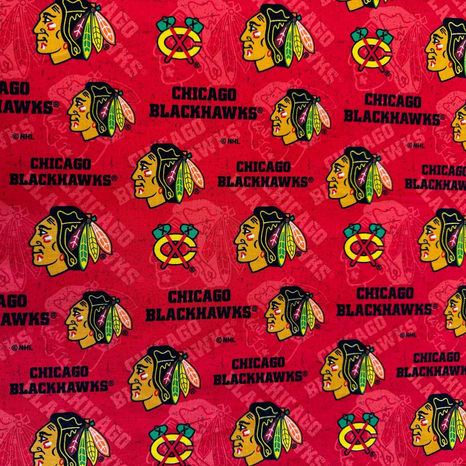 Licensed Chicago Blackhawks NHL cotton fabric featuring repeating team logos and hockey-themed print on cotton fabric.