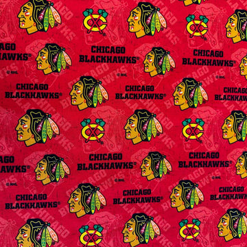 Licensed Chicago Blackhawks NHL cotton fabric featuring repeating team logos and hockey-themed print on cotton fabric.