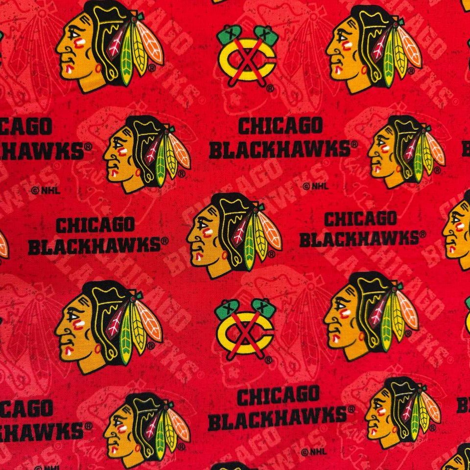 Licensed Chicago Blackhawks NHL cotton fabric featuring repeating team logos and hockey-themed print on cotton fabric.