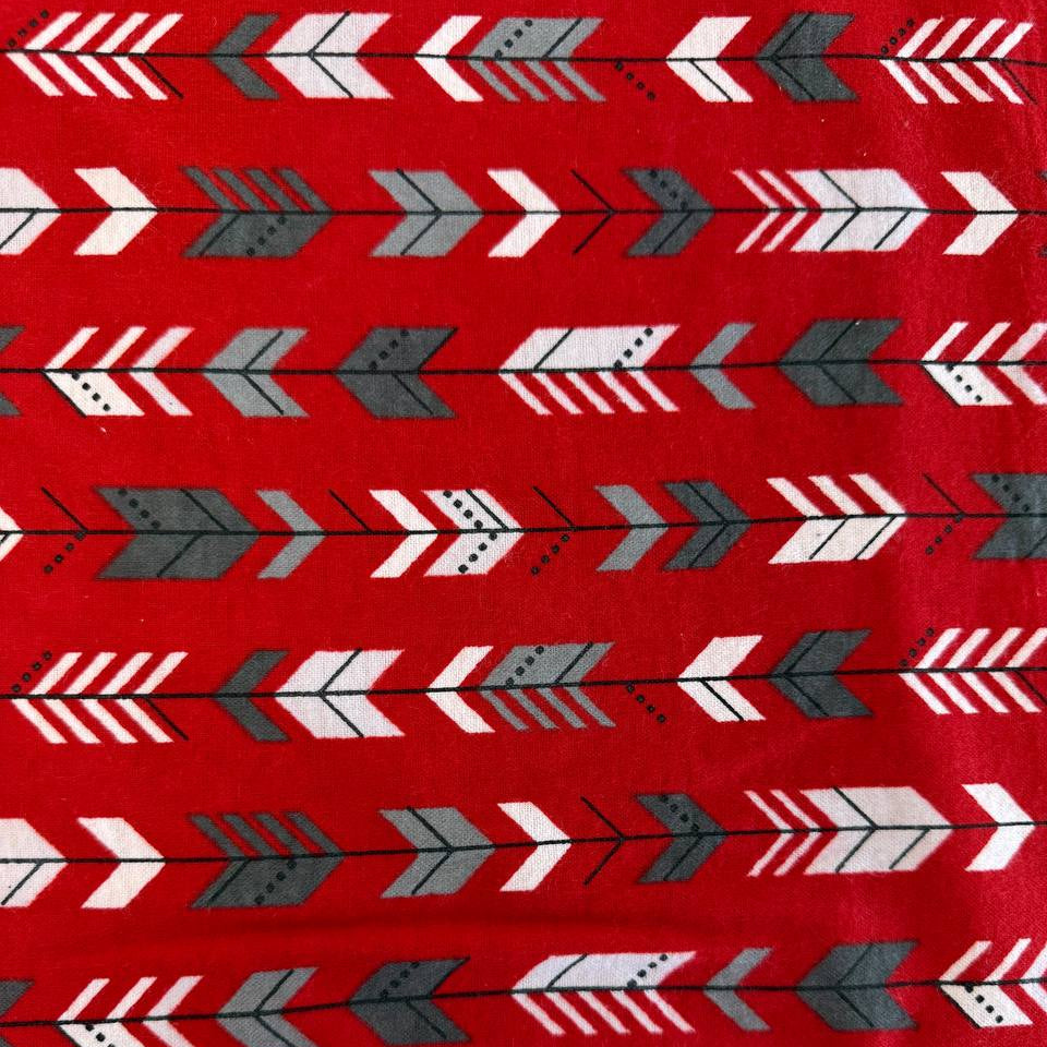 Red cotton flannelette fabric with white and gray arrow print pattern.