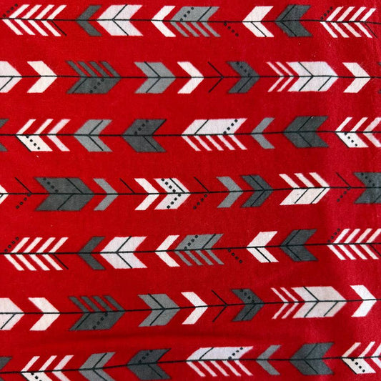 Red cotton flannelette fabric with white and gray arrow print pattern.